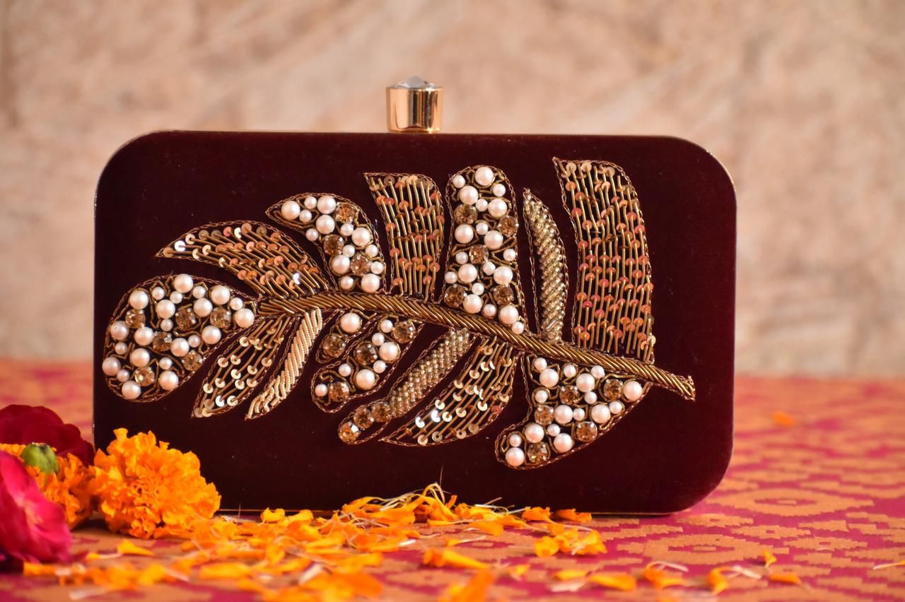 Maroon embroidered clutch with feather embroidery