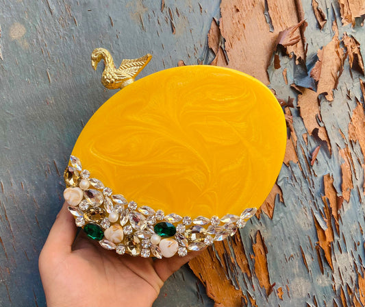 Oval resin clutch with designer knob and stone work - Yellow