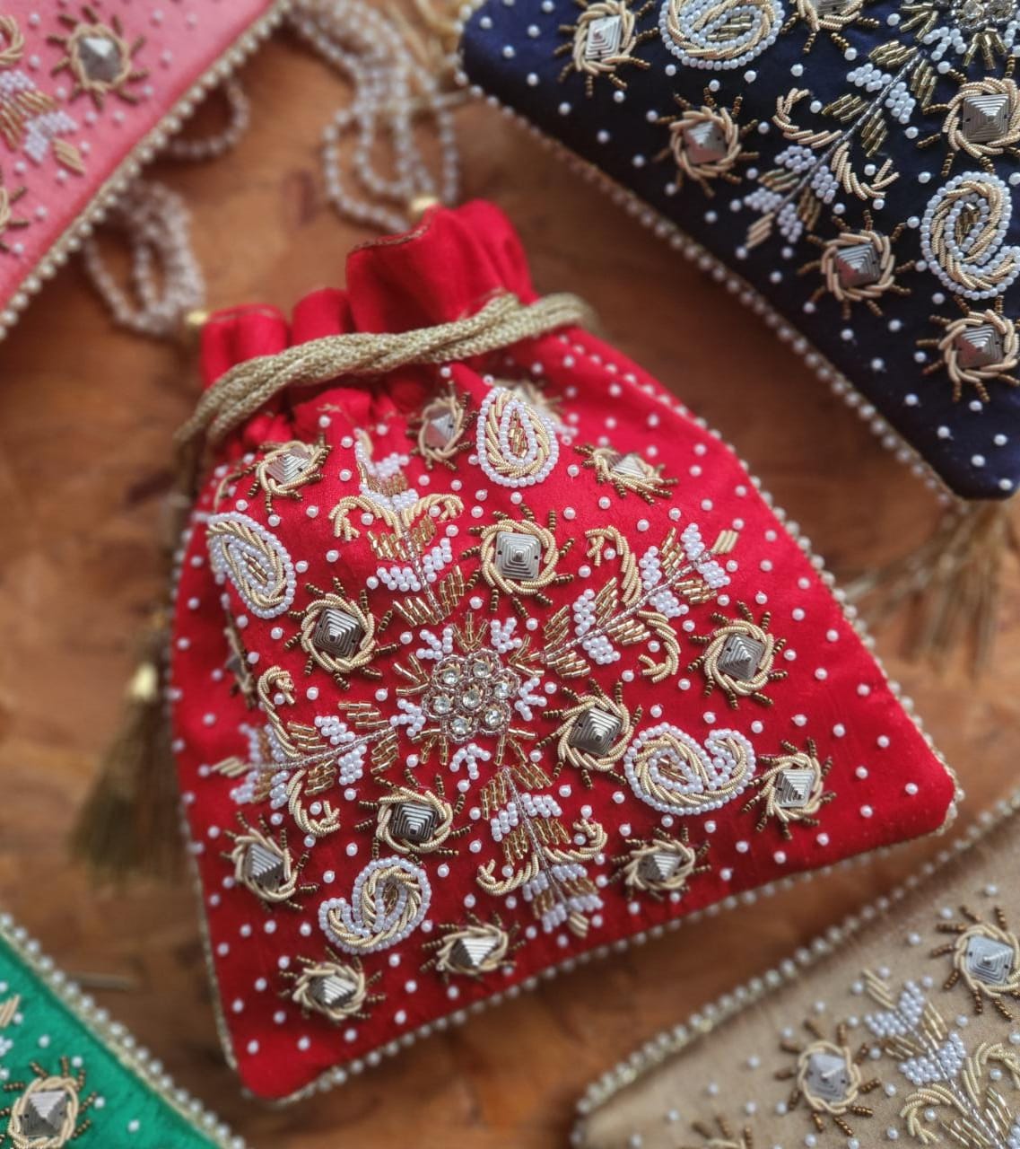 Raw silk fabric potli with zardosi and pearl work