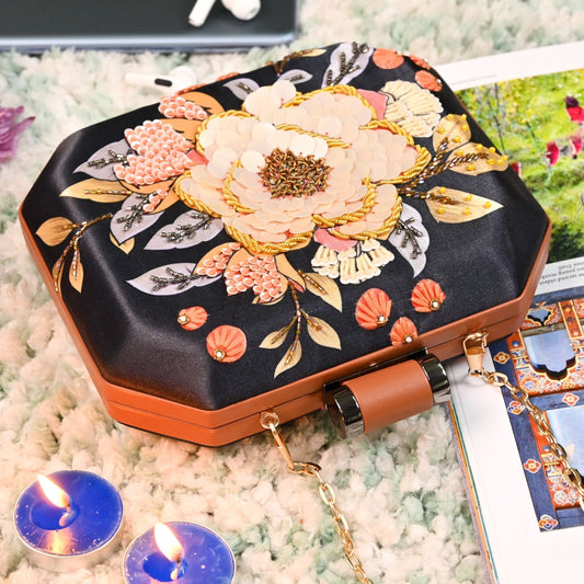 Black printed clutch with peach sequins & embroidered flower