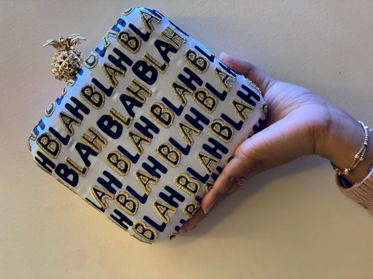 BLAH BLAH BLAH printed clutch with pineapple knob