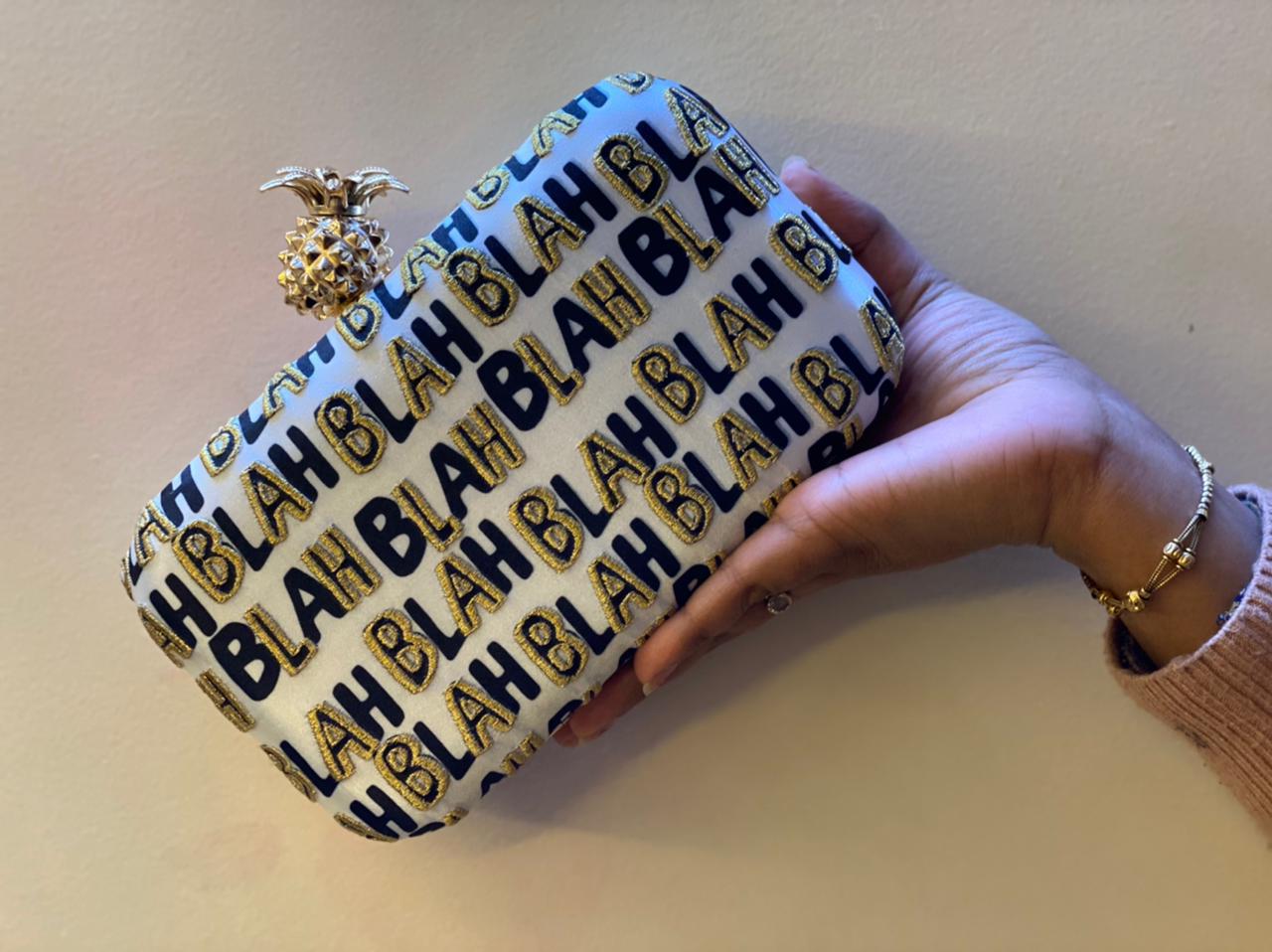 BLAH BLAH BLAH printed clutch with pineapple knob