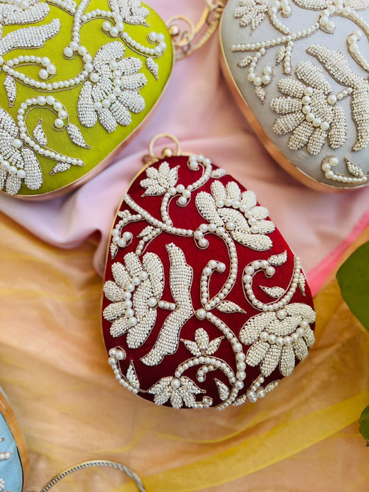 Oval clutch with pearl work and bangle