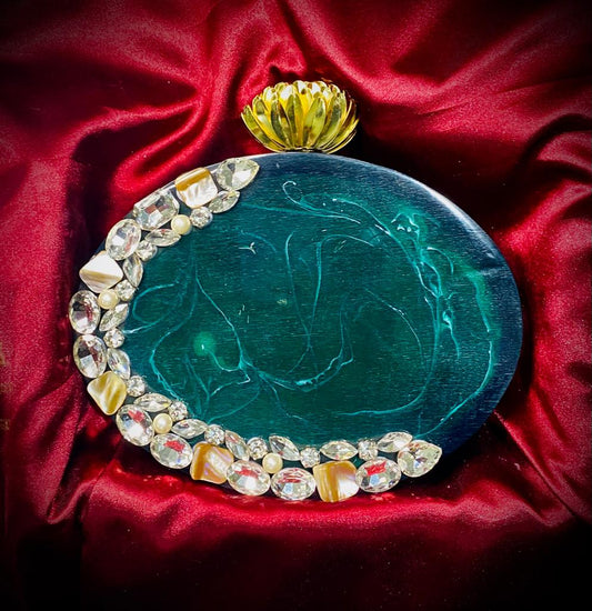 Oval emerald green resin clutch with flower knob and glass stone work